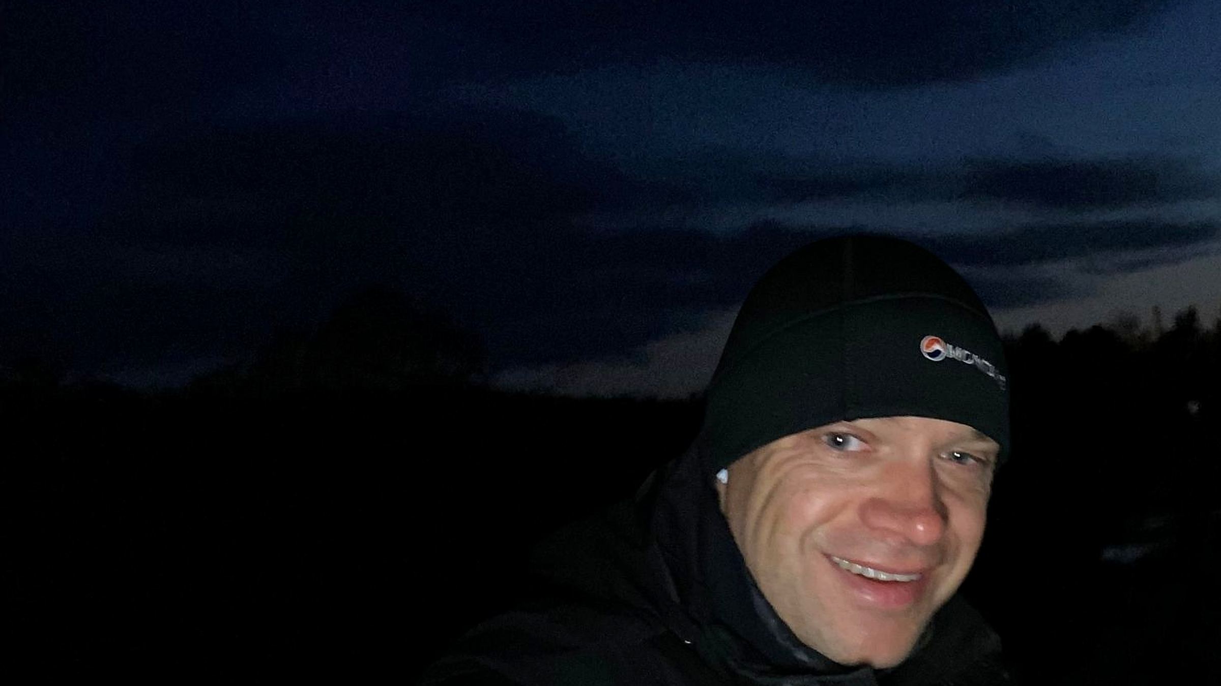 Pete walking on a country road before dawn